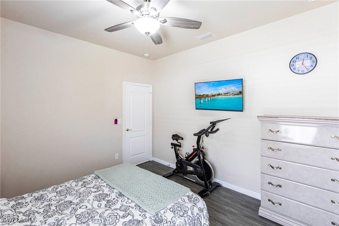2808 Via Piazza Loop Fort Myers, FL 33905 - Photo 28 of 49 a bedroom with a bed and a chandelier