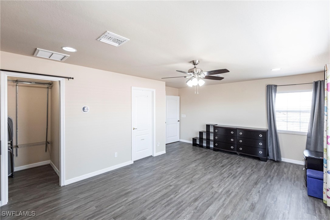 2808 Via Piazza Loop Fort Myers, FL 33905 - Photo 31 of 49 a living room with hard wood floors and a ceiling fan