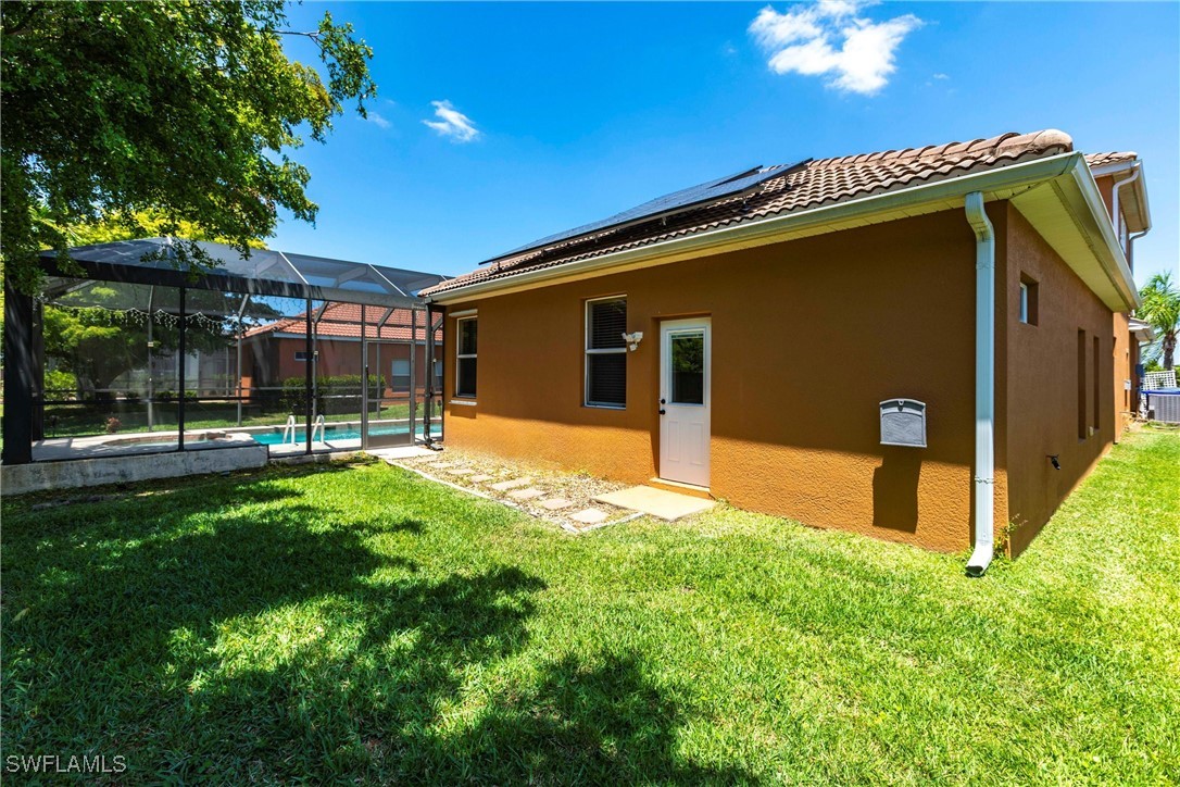 2808 Via Piazza Loop Fort Myers, FL 33905 - Photo 43 of 49 a backyard of a house with table and chairs