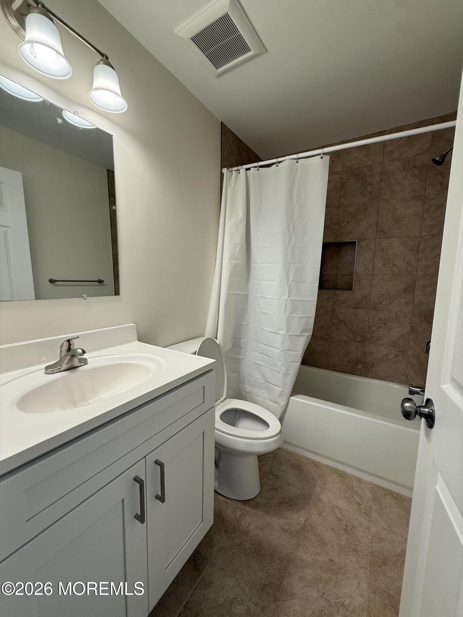 5 Canary Circle Howell, NJ 07731 - Photo 22 of 32 a bathroom with a sink a toilet a mirror and shower
