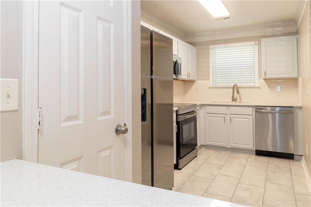 745 Crestwell Circle Atlanta, GA 30331 - Photo 11 of 38 a kitchen with white cabinets a sink and appliances