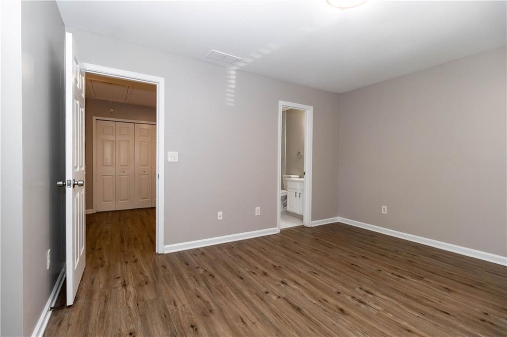 745 Crestwell Circle Atlanta, GA 30331 - Photo 17 of 38 wooden floor in an empty room with a window