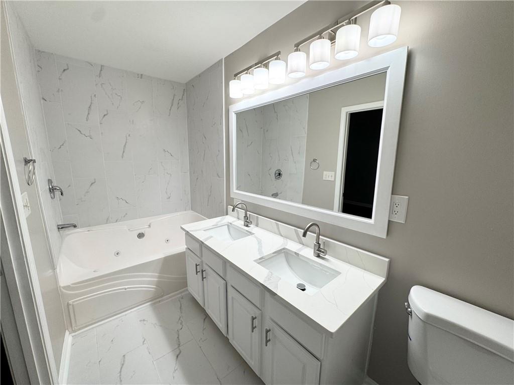 745 Crestwell Circle Atlanta, GA 30331 - Photo 28 of 38 a bathroom with a sink a toilet and a mirror