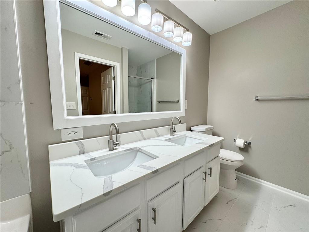 745 Crestwell Circle Atlanta, GA 30331 - Photo 29 of 38 a bathroom with a double vanity sink and a mirror