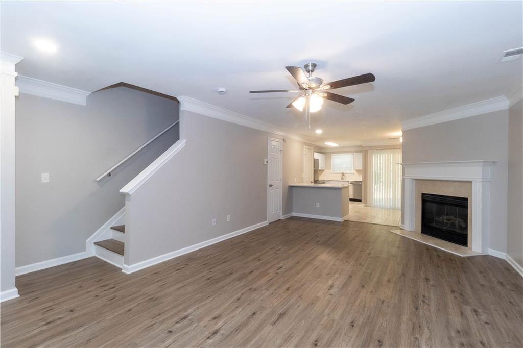 745 Crestwell Circle Atlanta, GA 30331 - Photo 3 of 38 a view of an empty room with wooden floor and a kitchen