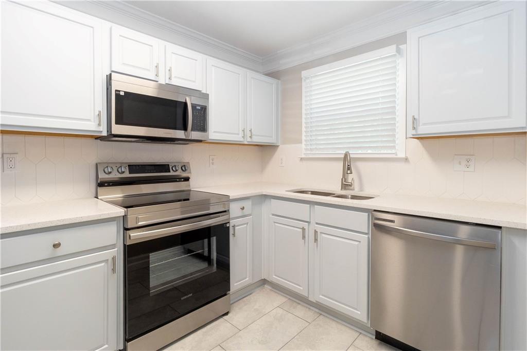 745 Crestwell Circle Atlanta, GA 30331 - Photo 9 of 38 a kitchen with white cabinets stainless steel appliances and sink