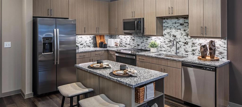 880 Lake Carolyn Parkway, Unit 436 Irving, TX 75039 - Photo 4 of 18 a kitchen with stainless steel appliances granite countertop a sink stove and refrigerator