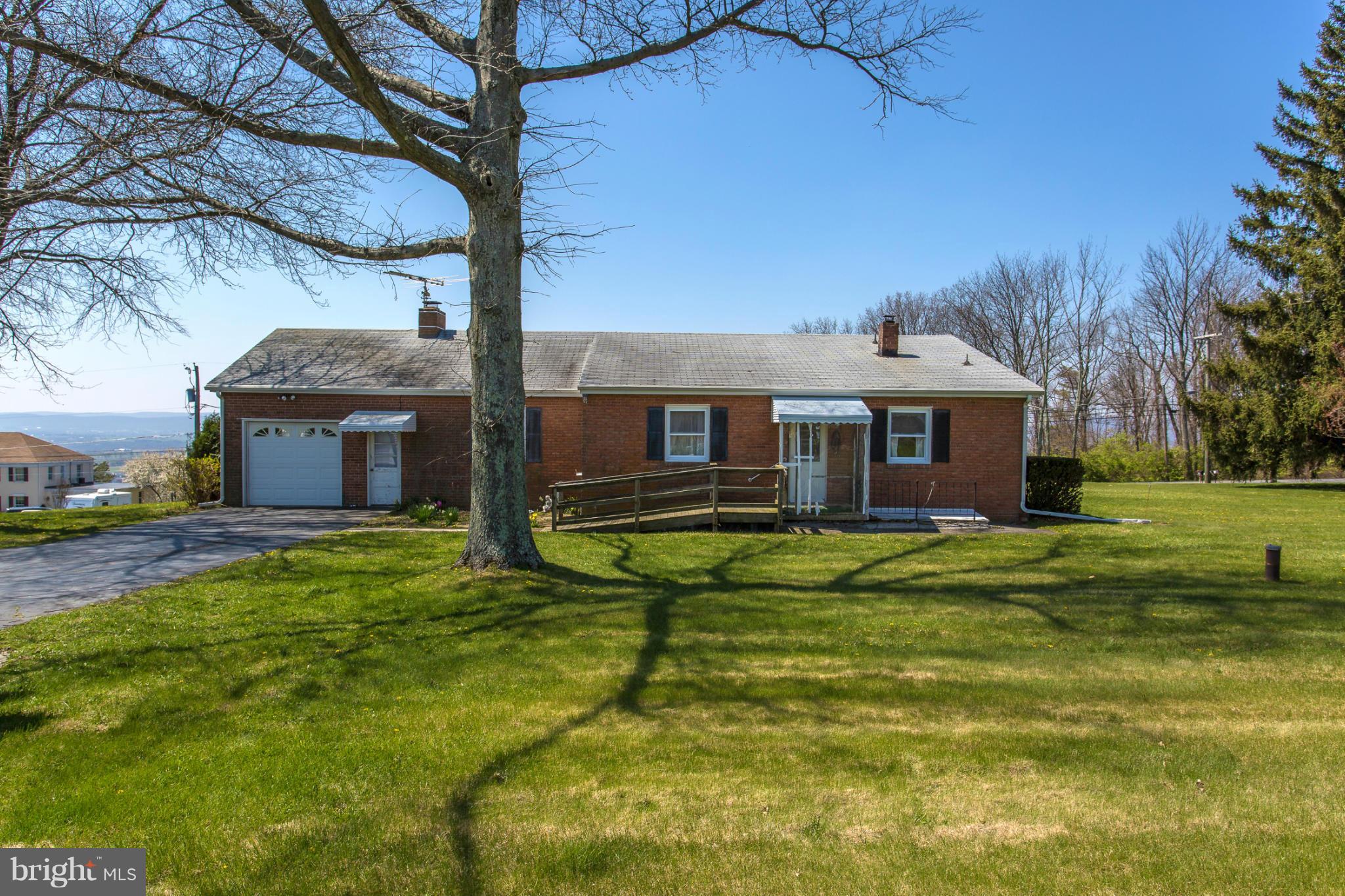 7417 Ridge Road Frederick, MD 21702 - Photo 3 of 30 a front view of a house with a garden