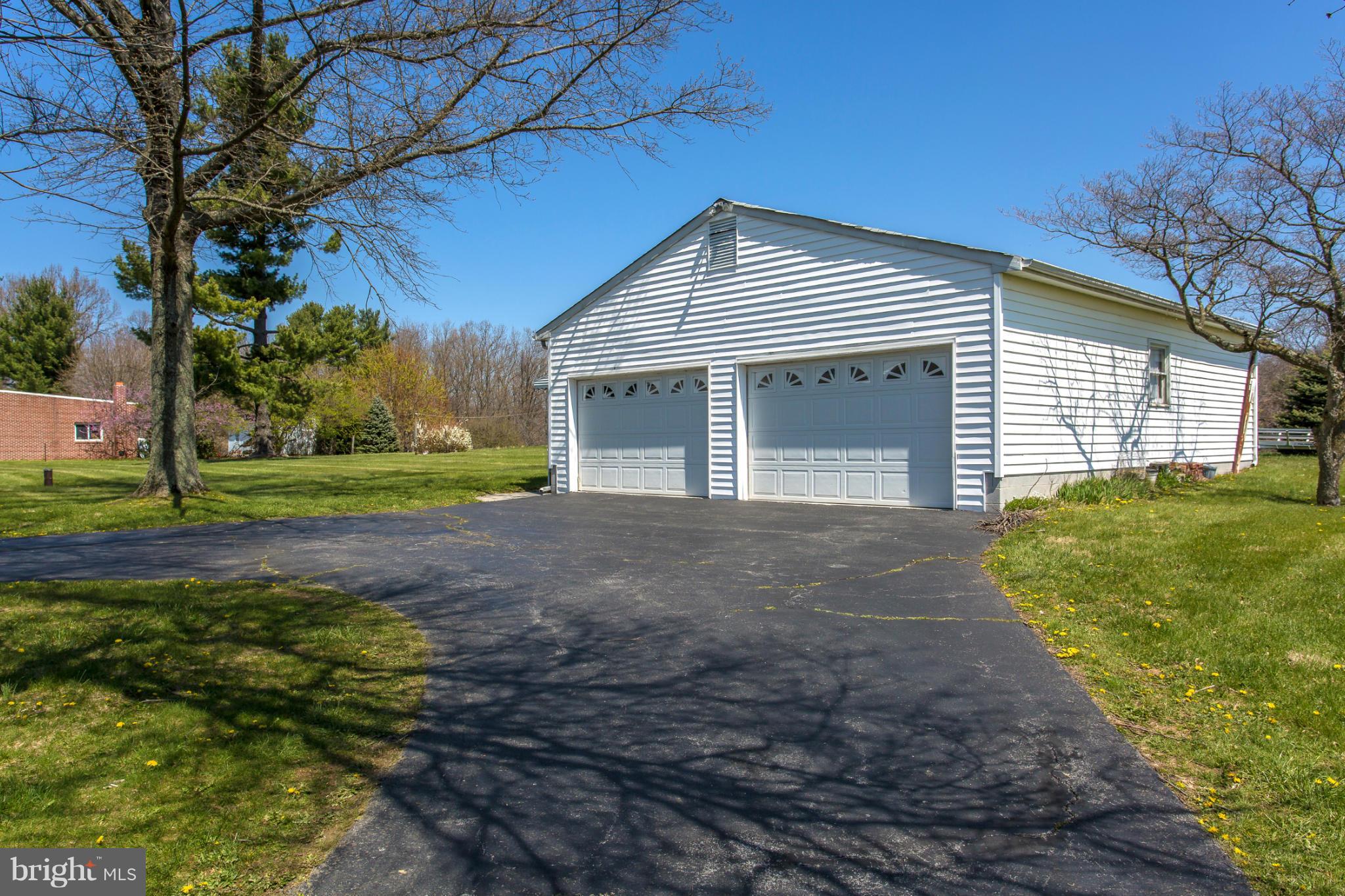 7417 Ridge Road Frederick, MD 21702 - Photo 5 of 30 a front view of a house with a yard and garage