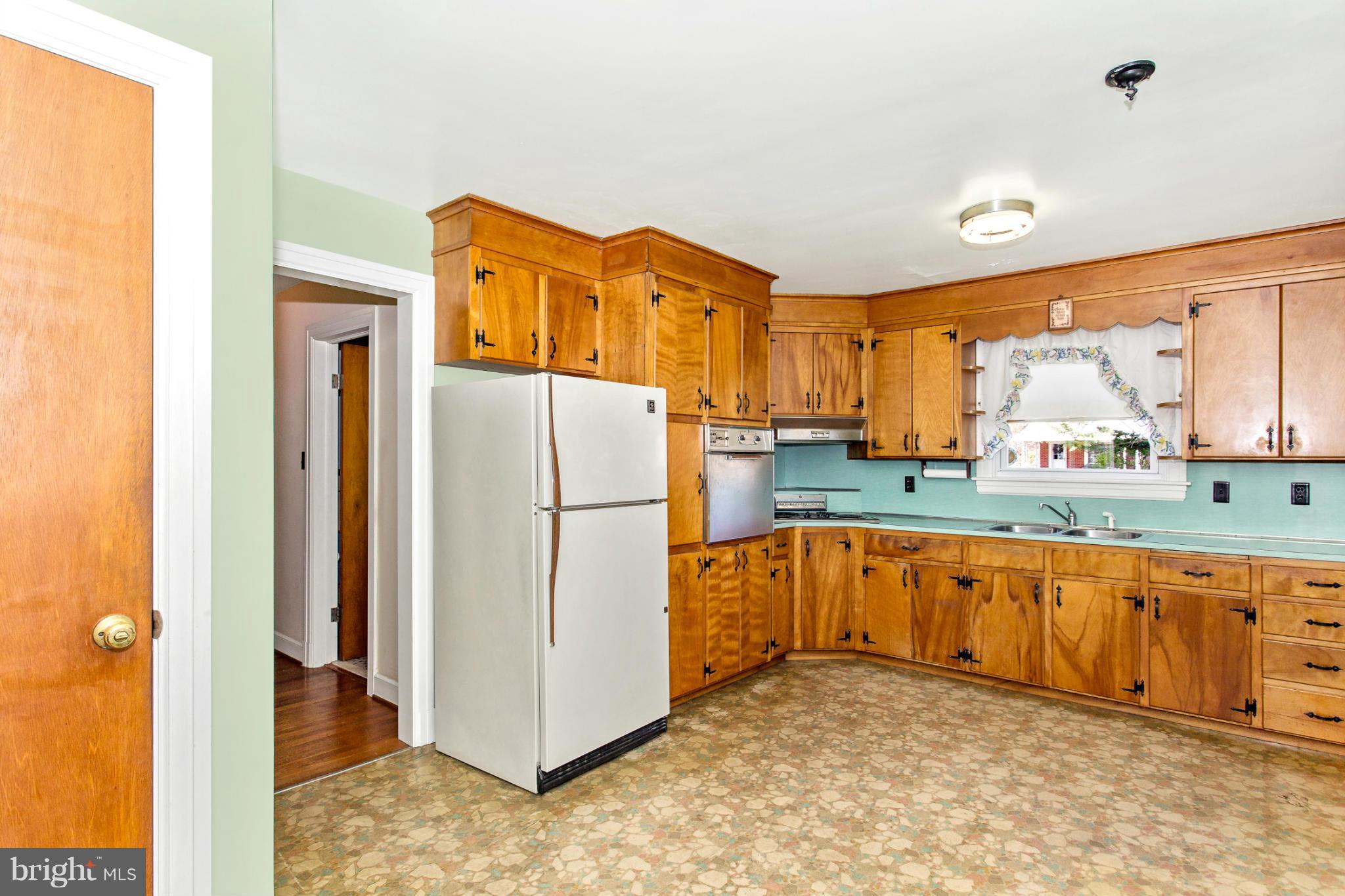 7417 Ridge Road Frederick, MD 21702 - Photo 8 of 30 a kitchen with stainless steel appliances granite countertop a refrigerator a sink and dishwasher with a dining table
