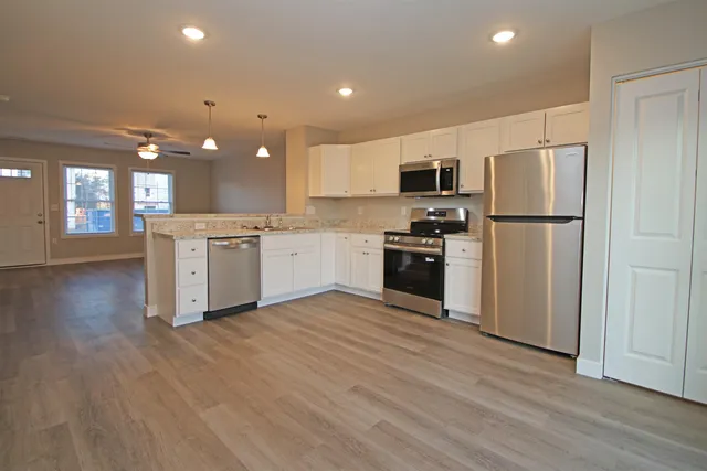 a kitchen with kitchen island a sink and a stove top oven