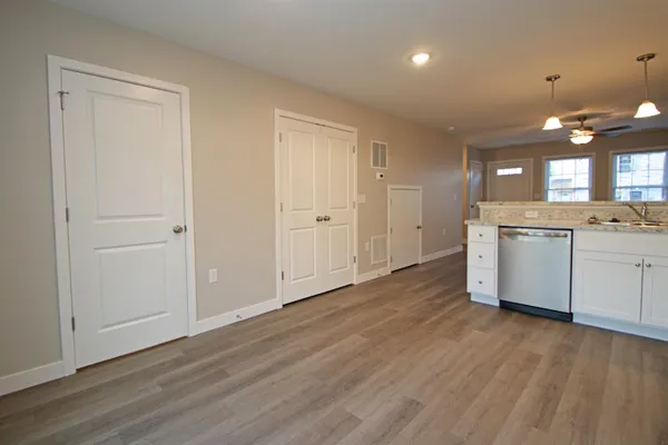 a view of a kitchen with a sink cabinets and wooden floor