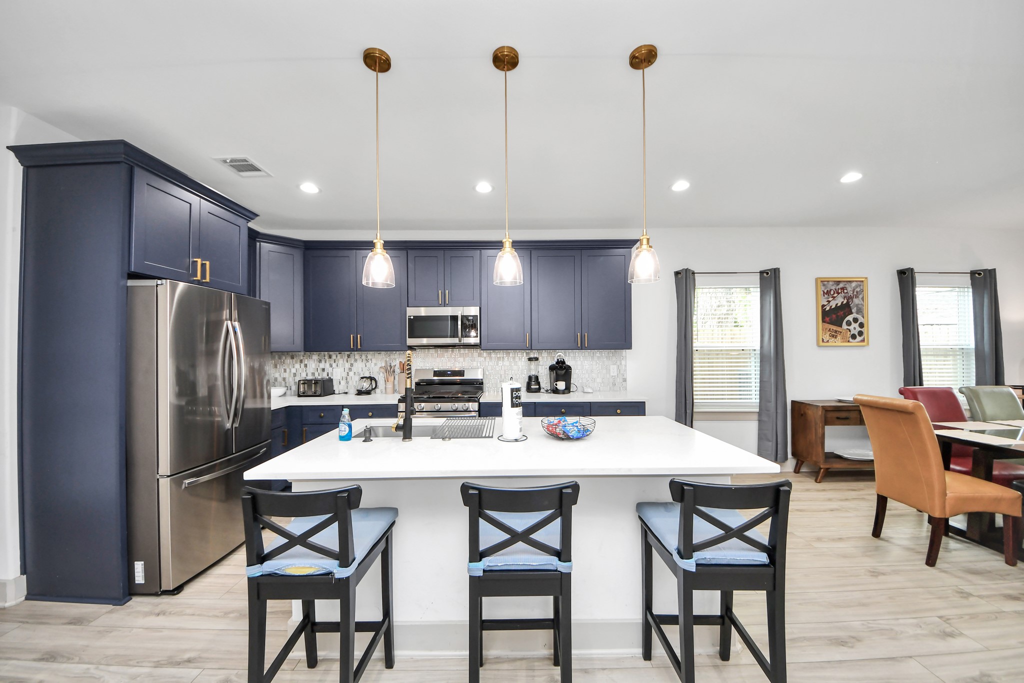 837 West Little York Road, Unit 1 Houston, TX 77091 - Photo 4 of 32 Modern Houston duplex kitchen featuring generous counter space, stylish cabinetry, stainless appliances, and an oversized island.