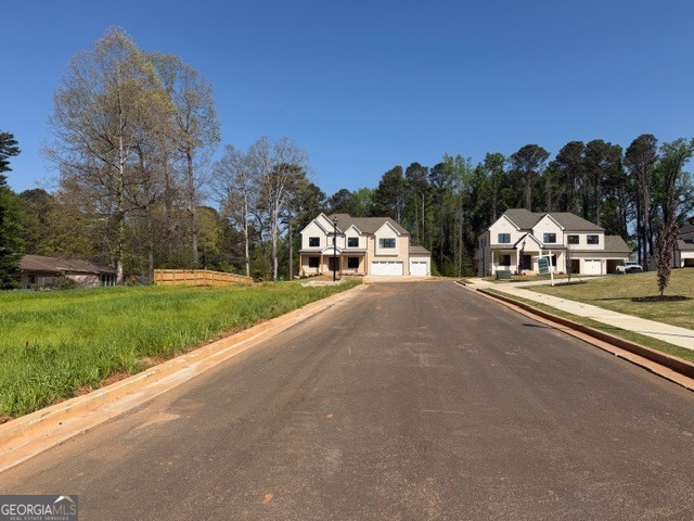 1976 Highgrove Court Atlanta, GA 30349 - Photo 16 of 48 a view of city street with a building and trees in the background