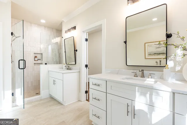 a bedroom with a large bed and windows