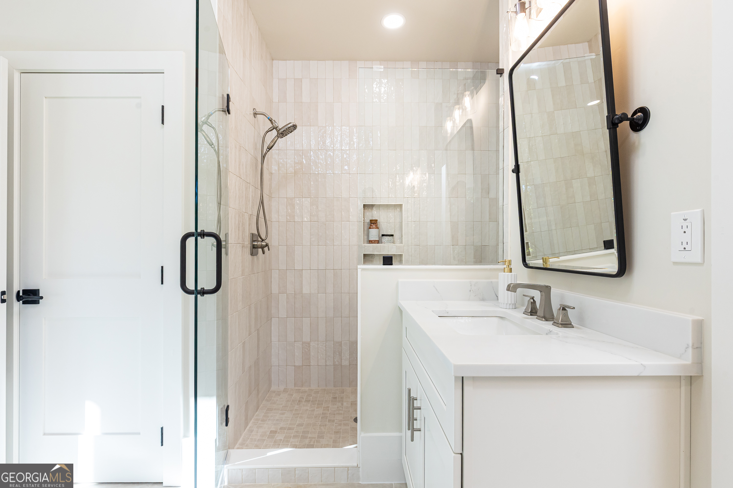 1976 Highgrove Court Atlanta, GA 30349 - Photo 24 of 48 a bathroom with a shower sink and mirror