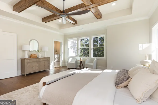 a bedroom with a bed wooden floor and window