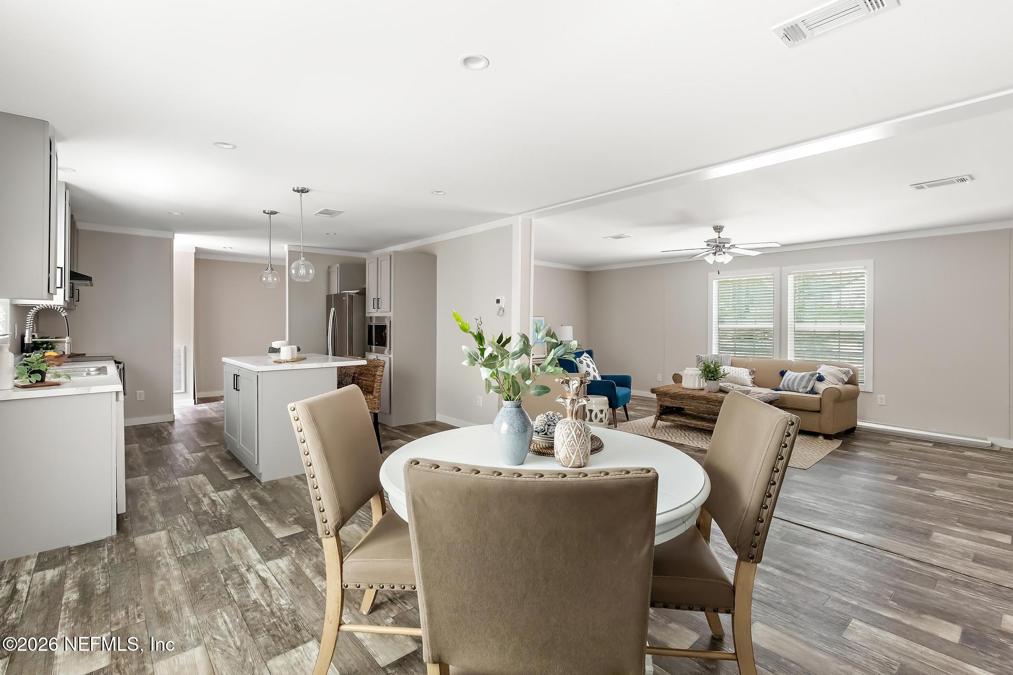 5333 Chicory Circle Middleburg, FL 32068 - Photo 18 of 53 a view of a dining room with furniture and wooden floor