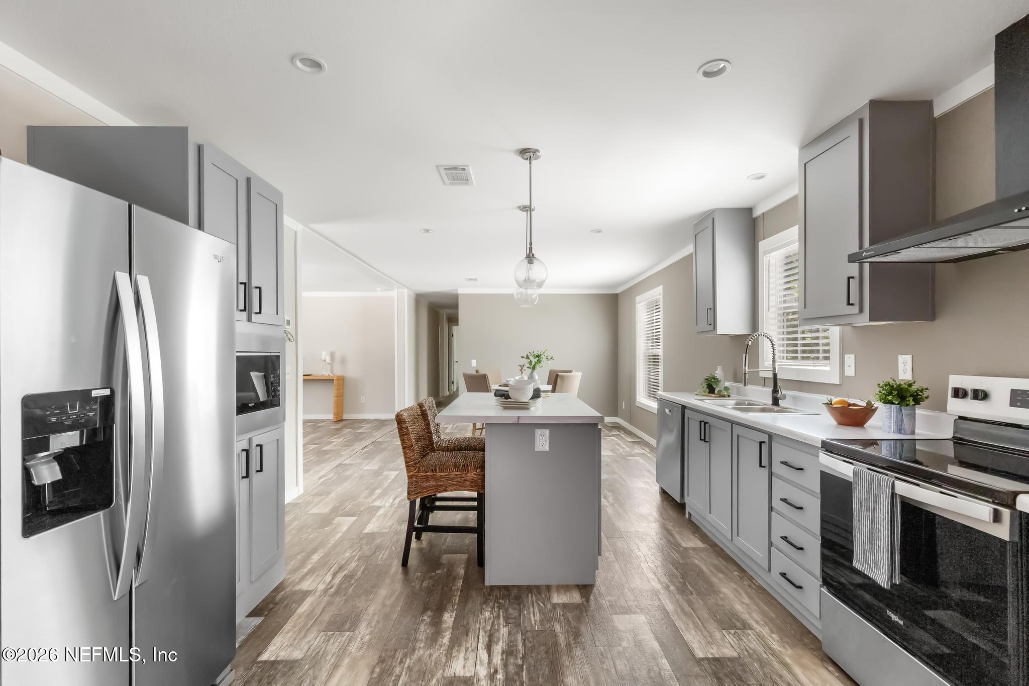 5333 Chicory Circle Middleburg, FL 32068 - Photo 24 of 53 a kitchen with stainless steel appliances a dining table chairs stove refrigerator and cabinets