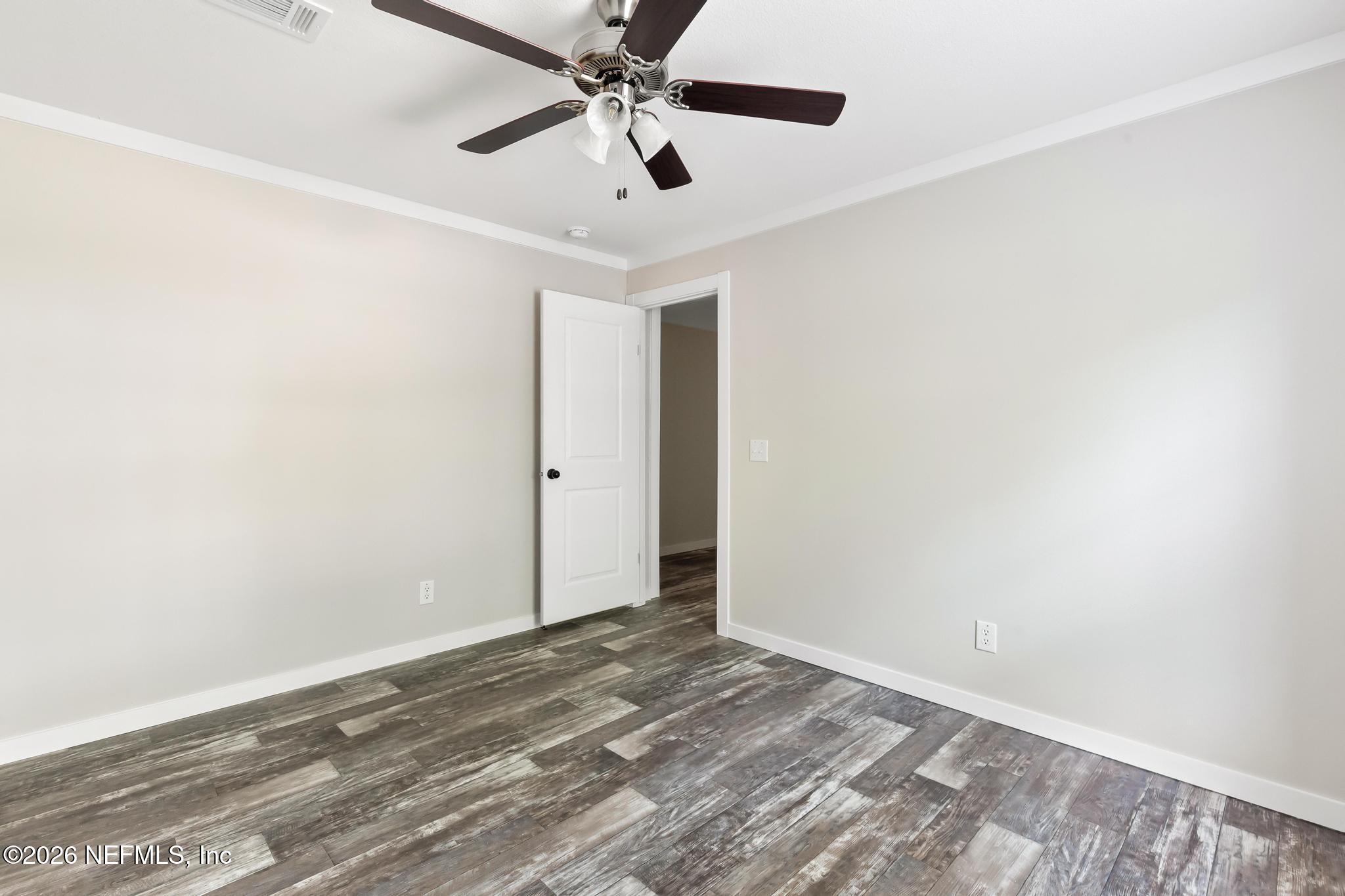 5333 Chicory Circle Middleburg, FL 32068 - Photo 36 of 53 an empty room with a ceiling fan and wooden floor