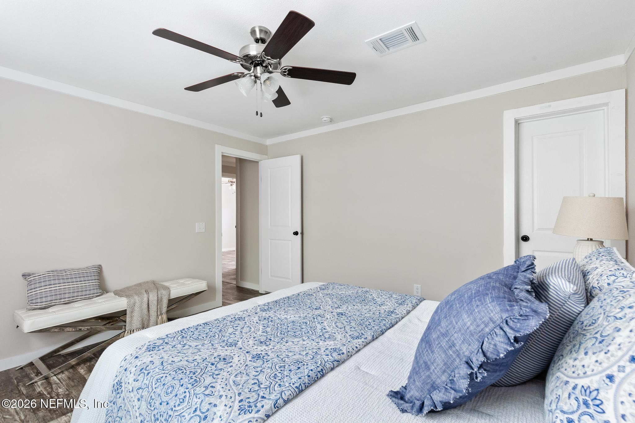 5333 Chicory Circle Middleburg, FL 32068 - Photo 38 of 53 a bedroom with bed and a chandelier