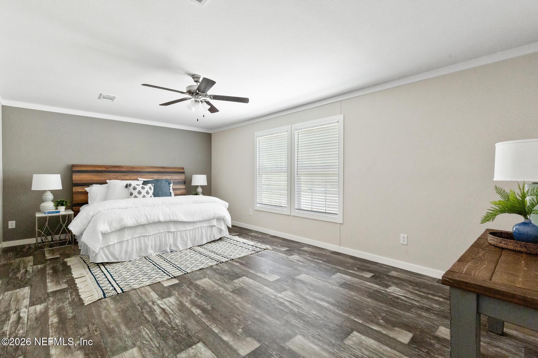 5333 Chicory Circle Middleburg, FL 32068 - Photo 39 of 53 a bedroom with a bed and a potted plant on the dresser