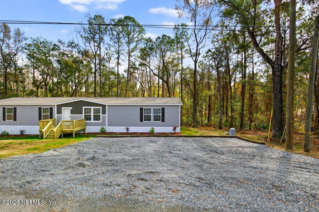 5333 Chicory Circle Middleburg, FL 32068 - Photo 9 of 53 a view of a house with a large tree and a big yard