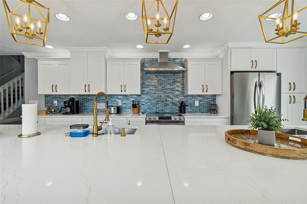330 6th Avenue Indian Rocks Beach, FL 33785 - Photo 8 of 52 a kitchen with stainless steel appliances granite countertop a sink a stove and a refrigerator
