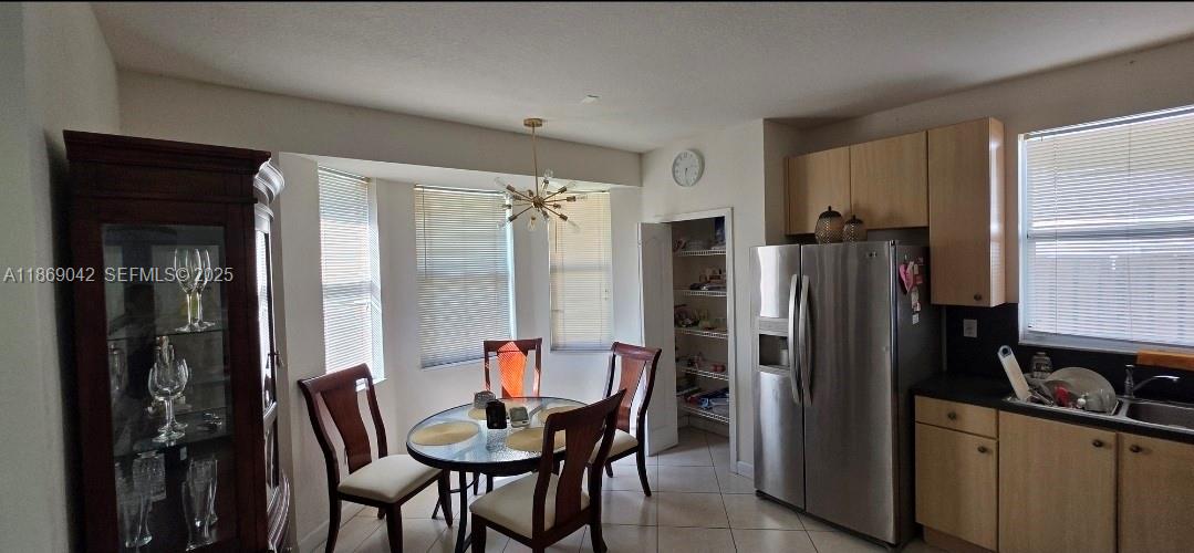 16448 Southwest 67th Terrace Miami, FL 33193 - Photo 13 of 54 a kitchen with a refrigerator and table chair