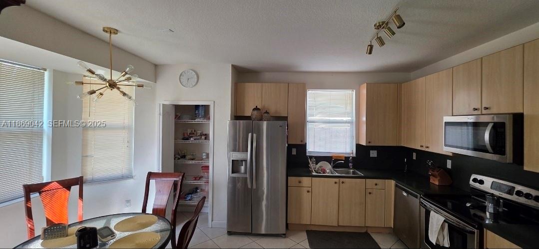 16448 Southwest 67th Terrace Miami, FL 33193 - Photo 15 of 54 a kitchen with stainless steel appliances granite countertop a refrigerator and a stove top oven