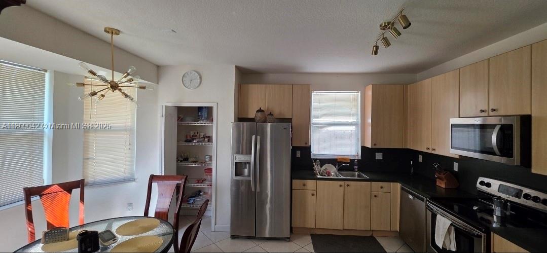 16448 Southwest 67th Terrace Miami, FL 33193 - Photo 15 of 54 a kitchen with stainless steel appliances granite countertop a refrigerator and a stove top oven