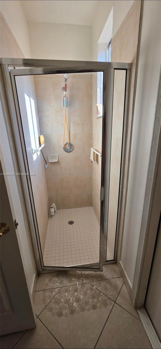 16448 Southwest 67th Terrace Miami, FL 33193 - Photo 17 of 54 a bathroom with a glass door shower and toilet