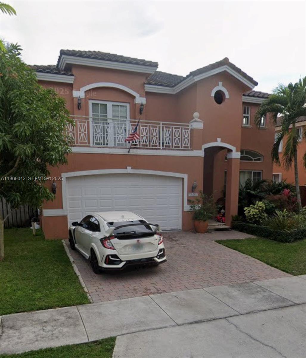 16448 Southwest 67th Terrace Miami, FL 33193 - Photo 2 of 54 a car parked in front of a house