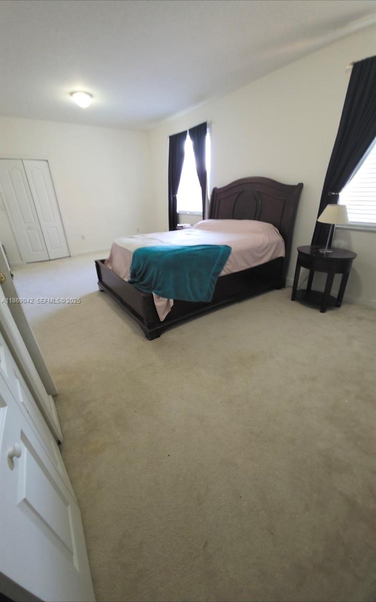 16448 Southwest 67th Terrace Miami, FL 33193 - Photo 26 of 54 a spacious bedroom with a bed and window