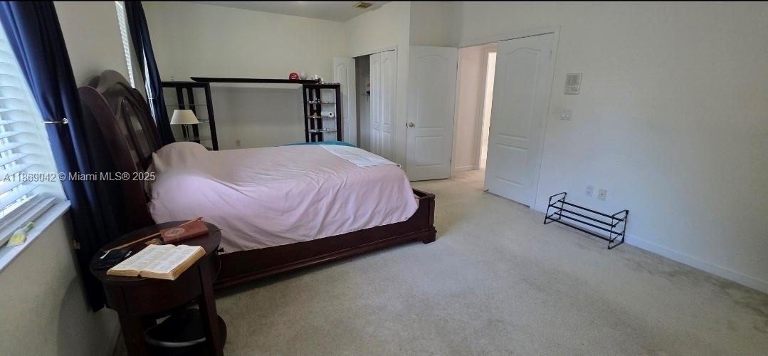 16448 Southwest 67th Terrace Miami, FL 33193 - Photo 29 of 54 a bedroom with a bed and a potted plant on the table