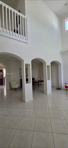 a view of a livingroom with furniture and cars