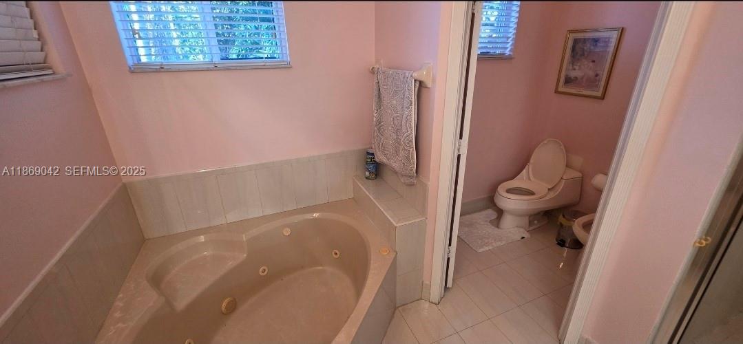 16448 Southwest 67th Terrace Miami, FL 33193 - Photo 36 of 54 a bathroom with a granite countertop shower and a toilet