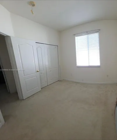 a view of backyard with wooden fence and large trees