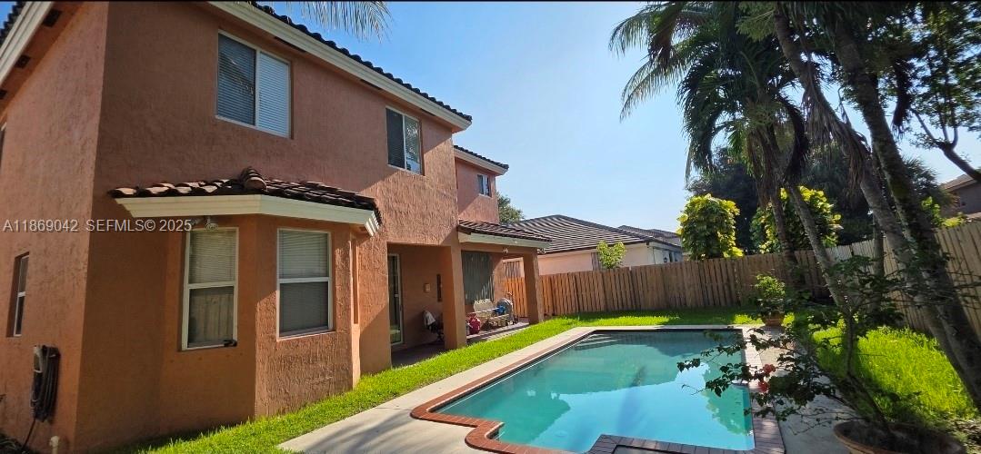 16448 Southwest 67th Terrace Miami, FL 33193 - Photo 44 of 54 a view of a house with backyard and swimming pool