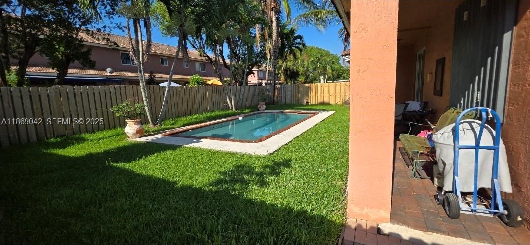 16448 Southwest 67th Terrace Miami, FL 33193 - Photo 51 of 54 a view of a backyard with brick wall and plants