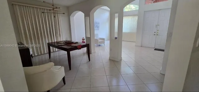 a dining room with furniture and wooden floor