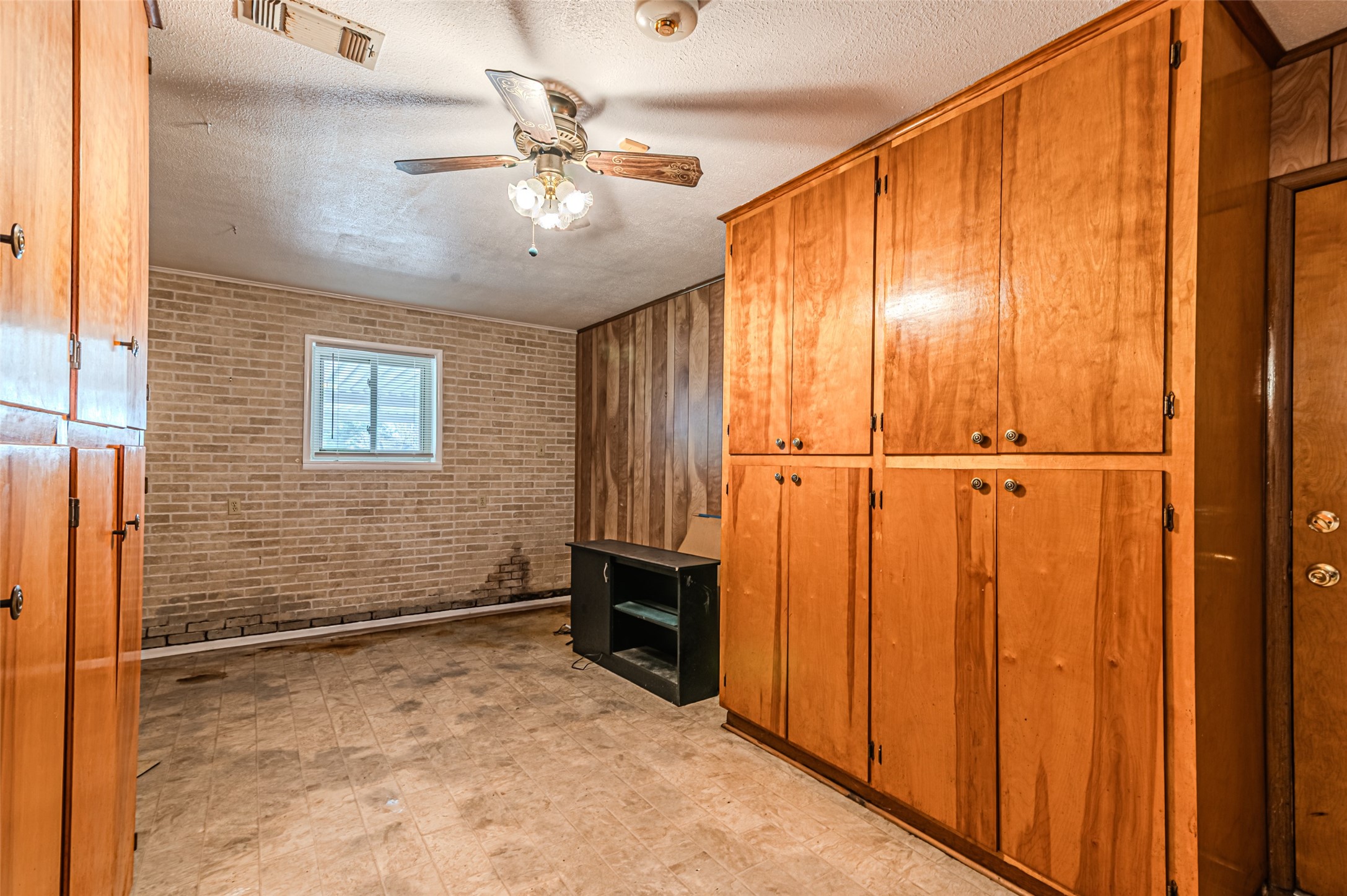 1126 10th Street Hempstead, TX 77445 - Photo 22 of 34 an empty room with chandelier fan and windows