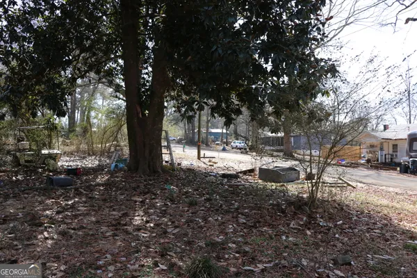 a backyard of a house with table and chairs