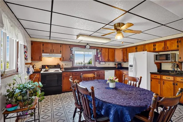 a bathroom with a toilet sink and shower curtain