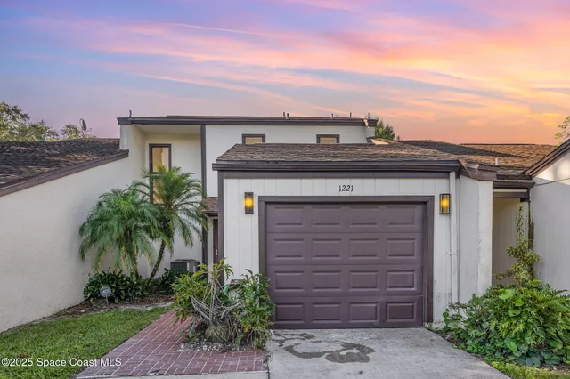 front view of a house with a potted plant