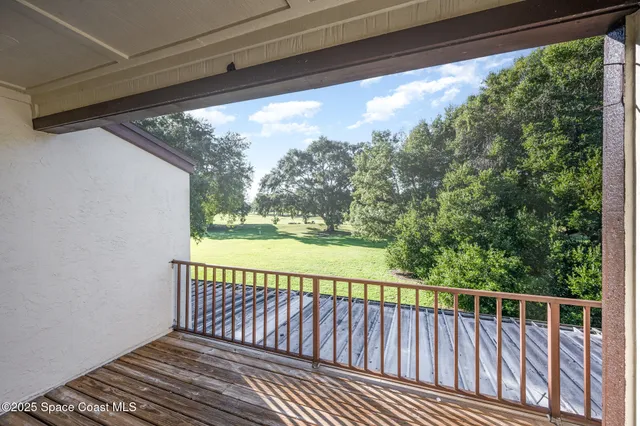 a view of a balcony with wooden floor