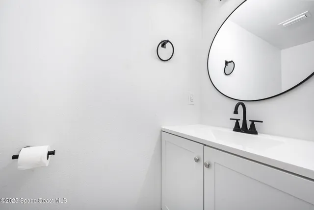 a bathroom with a sink and mirror