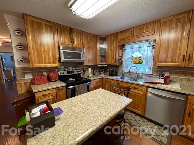 845 Sandy Level Church Road Bostic, NC 28018 - Photo 13 of 46 a kitchen with stainless steel appliances granite countertop sink stove top oven and cabinets