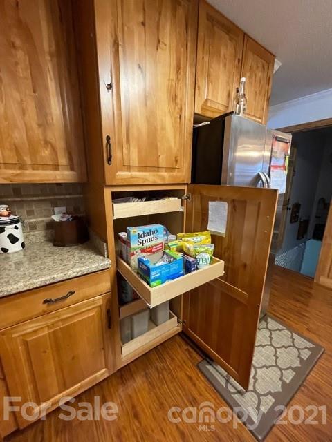 845 Sandy Level Church Road Bostic, NC 28018 - Photo 14 of 46 a kitchen with granite countertop a refrigerator and a stove top oven