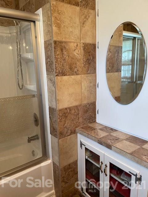 845 Sandy Level Church Road Bostic, NC 28018 - Photo 21 of 46 a bathroom with a granite countertop sink a mirror and shower